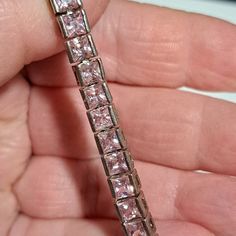 Silver color and pink stone tennis style bracelet very bright and shiny looking